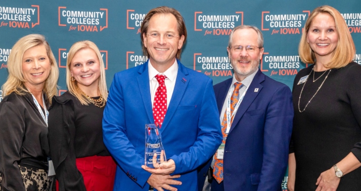 Dr. Beau Beecher (center) accepts the Outstanding Business and Industry Award from Community Colleges for Iowa on behalf of Kimball and Beecher Family Dentistry for their support of and long-standing partnership with Hawkeye Community College. Pictured with Dr. Beecher are Dr. Todd Holcomb (left), president of Hawkeye Community College; and Dr. Emily Boge (right), Hawkeye