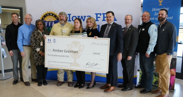 Amber Greiman is presented with a check for $500 recognizing her as one of Iowa